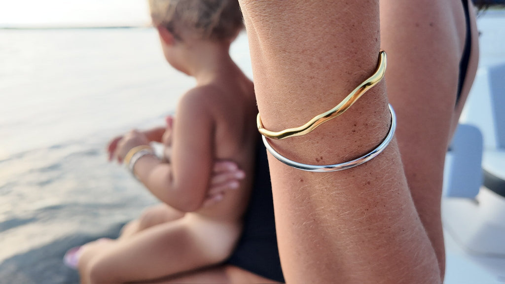 Rose smooth silver bangle stacked on an adult wrist