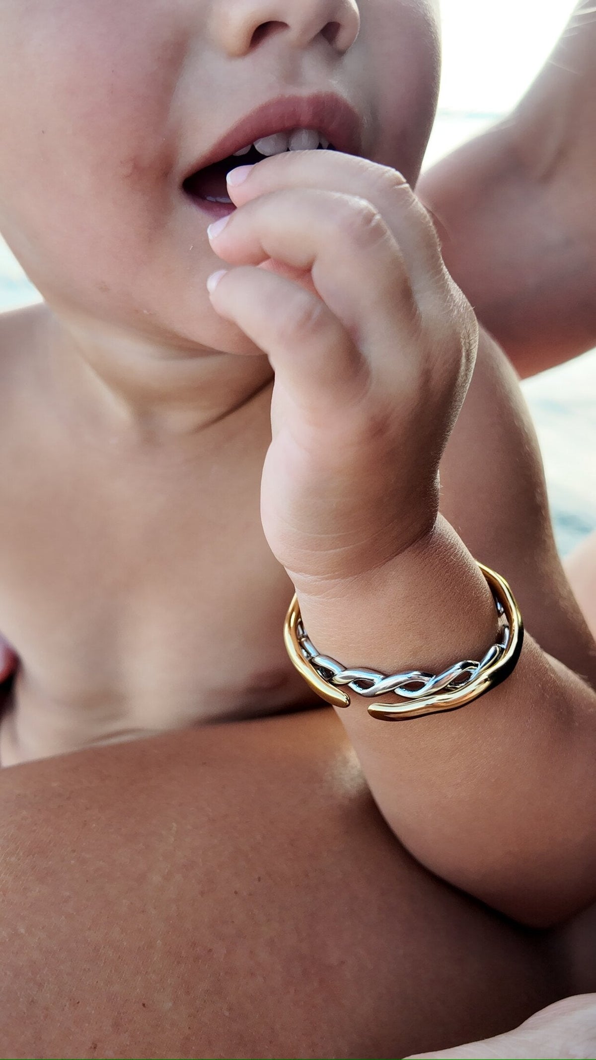 Faye woven silver bangle on a toddler wrist