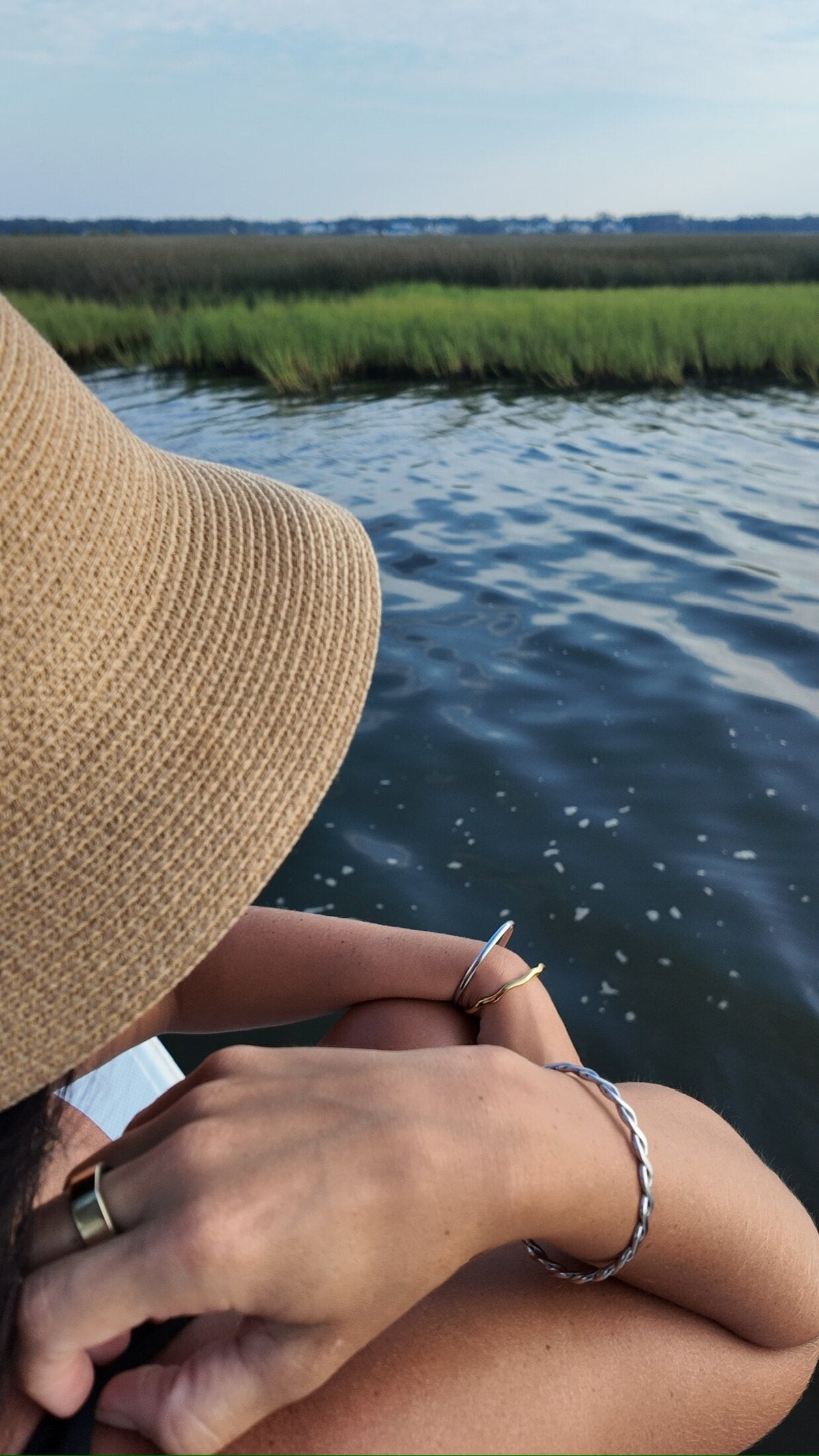 Penny Faye bangle on a wrist against the marsh